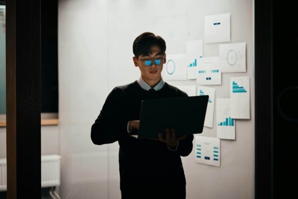 Man standing whilst using laptop