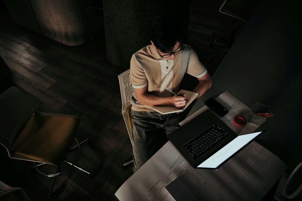 Man taking notes in the dark