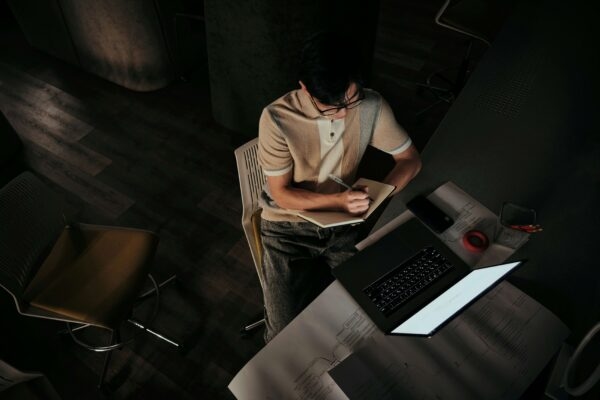 Man taking notes in the dark